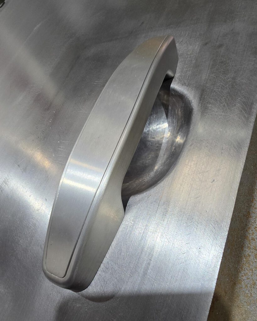 Sheet metal door panel shaping